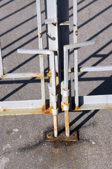 Two vertical metal bolts on the iron gate №765