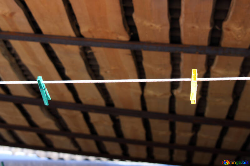 Two pegs on the washing line under canopy №684