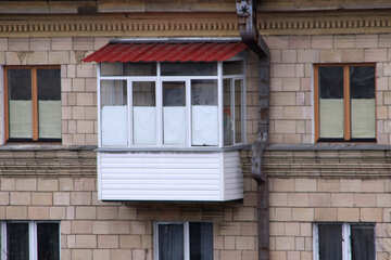 Balcony under the roof of glass and trimmed with metal and plastic siding №1356