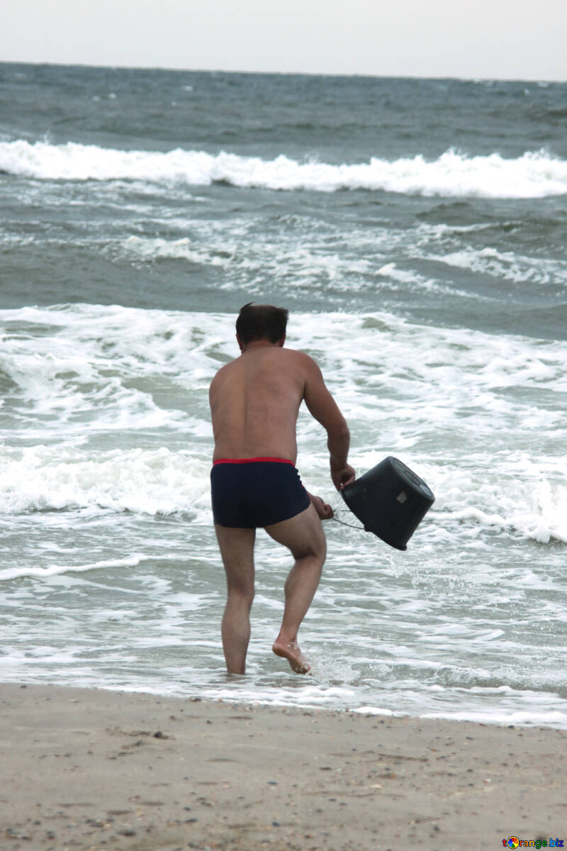 Un homme recueille l`eau dans le seau №13467
