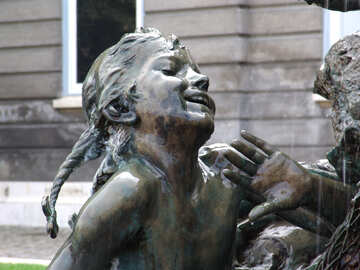 A sculpture of child in the fountain