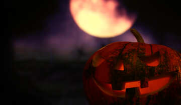 Halloween pumpkin in the night sky with the moon