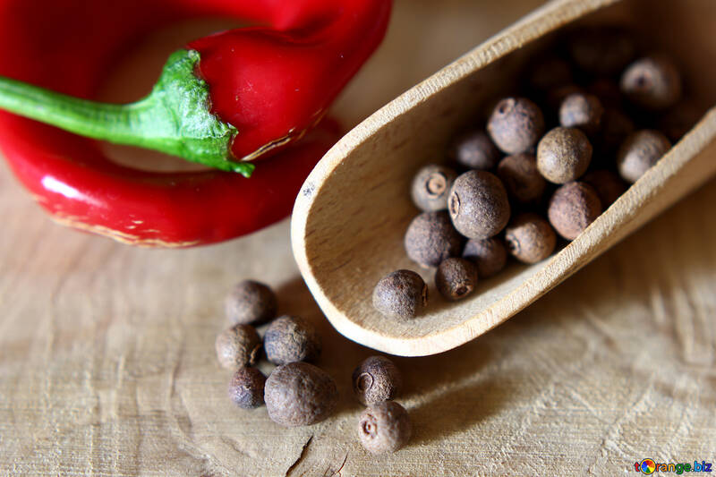 Black pepper and red pepper on a wooden table №46622