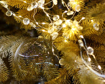 Transparent Christmas toy on a Christmas tree with bulbs №47769