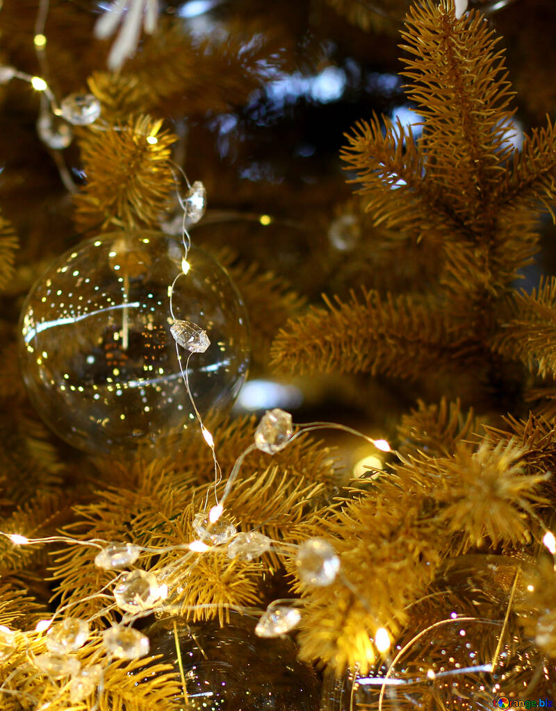 Bola de Navidad hecha de cristal y una guirnalda en un árbol de navidad №47567