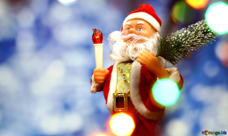 Santa Claus toy brings Christmas tree at blue snowy night bokeh background and blurred lights foreground. Red lantern torch to light the way. Big Copyspace concept New Year`s market banner, poster. №48161