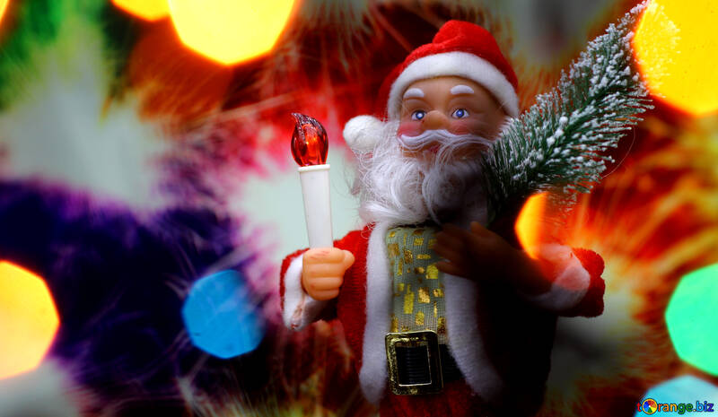 New Year`s card with Santa Claus toy brings Christmas tree at glow sparks bokeh background in the colors of the French flag. №48168