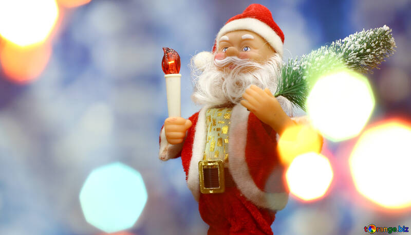 Santa Claus toy brings Christmas tree at blue snowy night bokeh background and blurred lights foreground. №48164