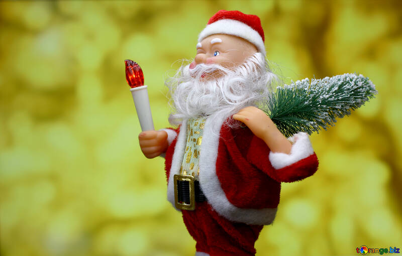 New Year`s card with cheerful Santa Claus toy brings Christmas tree at glow gold bokeh background. №48151