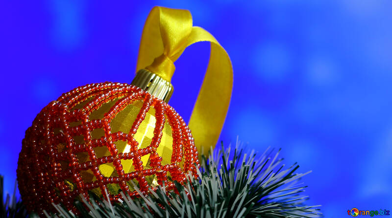 Christmas ball decorated with beads on blue blurred background №48063