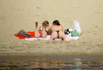 Two girls sunbathing on the beach №49700