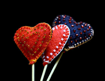 Hearts made of felt on a dark background in isolation