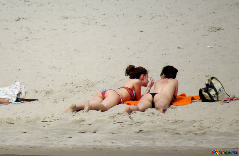 Two girls are sunbathing on the sand №49698