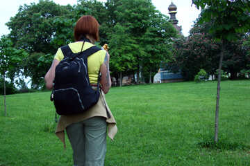 Girl   backpack  is   mountain.  Type  behind.