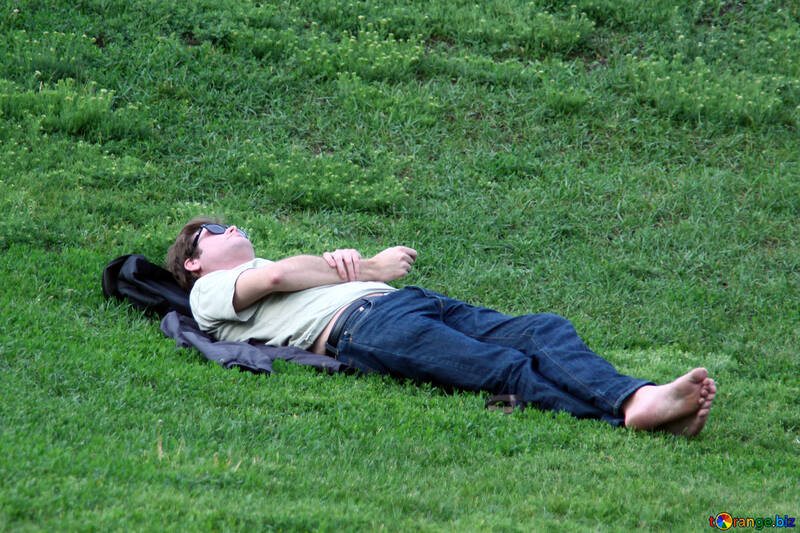 Чоловік лежить на траві босоніж. №5091