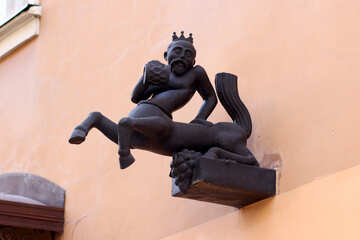 Un uomo sulla statua del centauro della parete del cavallo del gargoyle della sporgenza №51996