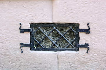Tower of church or castle  white wall  Metal window grate №51630