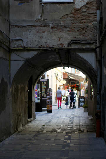 An alley people walking under stone bridge №51877