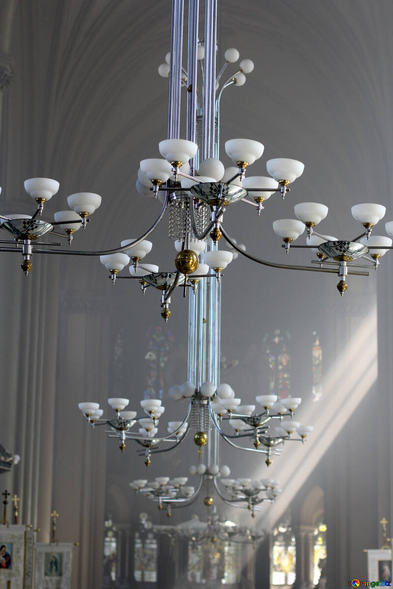 Ornate lighting fixtues hanging in a sun-lit hall №51678