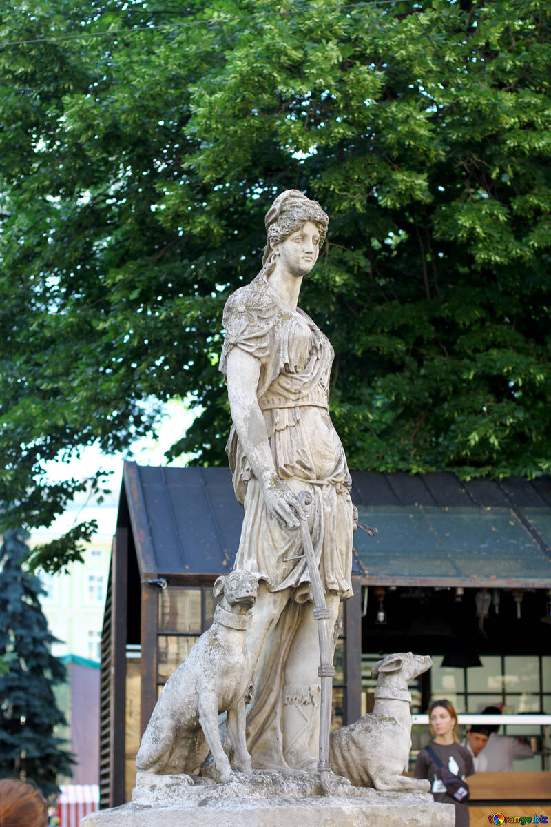 A statue under a tree in front of a building №51991