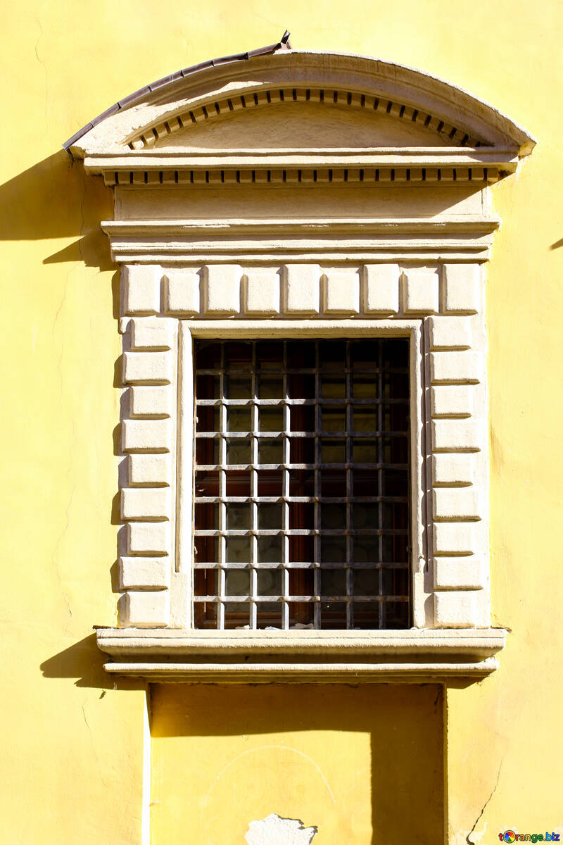 A barred window yellow house №51646