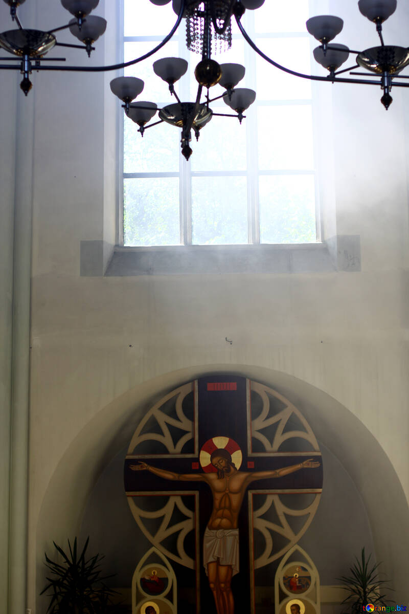 Sunlight shining in through window above Jesus on the cross church №51694