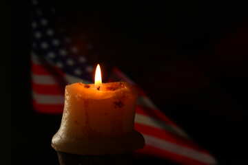 A candle and american flag behind candle №52482