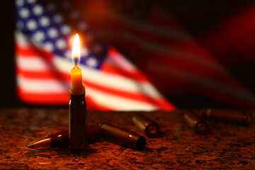 Flag in the background, a lit candle, and scattered bullets №52503