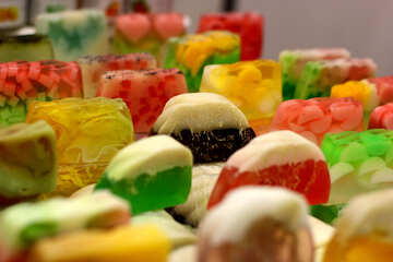 an array of gummy candies with colorful bottoms and white tops №53090