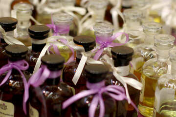bottels with caps and ribbon knotted purple oils bottle №53015
