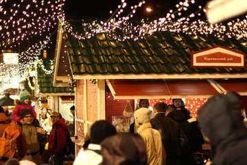 people outside walking around with lights up christmas market Celebration house lighting decoration background №53478