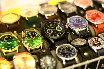 A group of different coloured watches on display