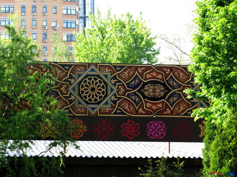 a bridge railing or canopy above a store with beautiful deisgn, trees and building in the distance art billboard №53366
