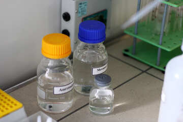 Three bottles of clear liquid Two large bottles, one small medical liquid laboratory chemical water glass №54650