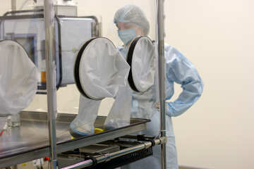 People in medical gear experimenting in a sterile environment Medical lab hermetic box research equipment №54631
