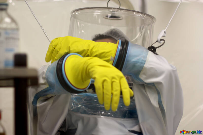 person covered in protective gear wearing yellow gloves hazmat siut №54627