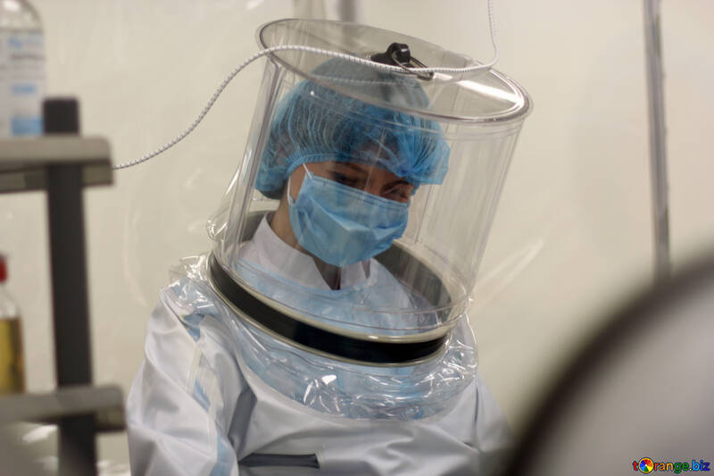 person wearing scrubs and a plastic vacuum helmet scientist with mask hood covid patient quarantine protective docotr  lady №54596