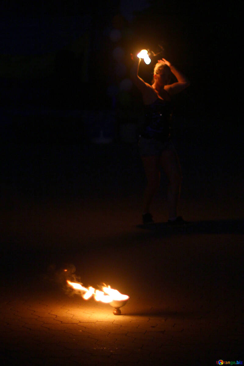 person standing over fire in darkness №54380