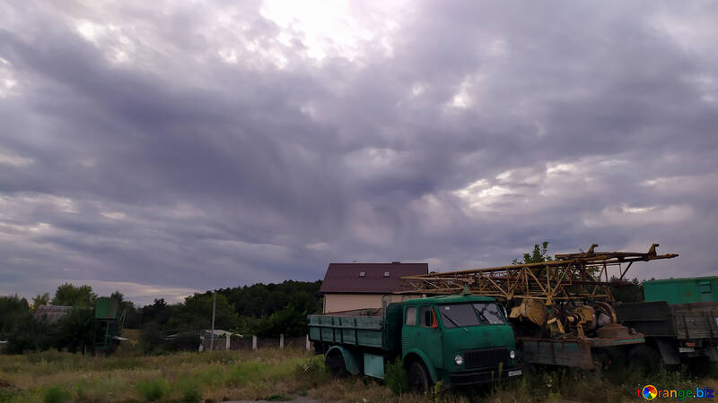 truck in front of a house with clouds in sky №55881