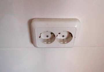 Close-Up of a Vintage White Electrical Outlet with Dust and Scratches №56431