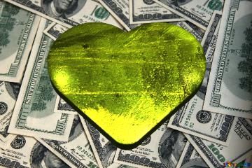 Gold metal Rich man`s heart on dollars background