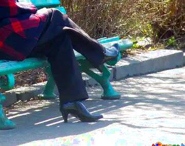 FX №17751 Blue color. A woman relaxing in the park on bench.