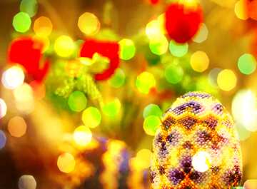 FX №208656 Easter egg decorated with beads on the background of flowers Bokeh Background