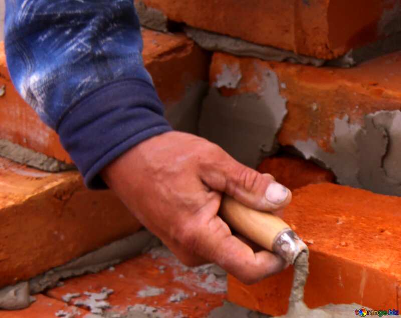 worker builds a wall of bricks. the builder on a building makes bricklaying. №2891