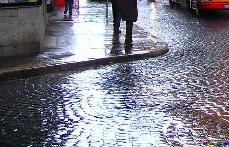 a person walking in the rain on the footpath №12430